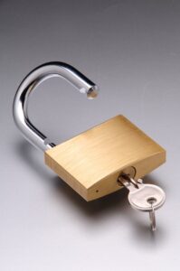 an unlocked padlock with key inserted and turned